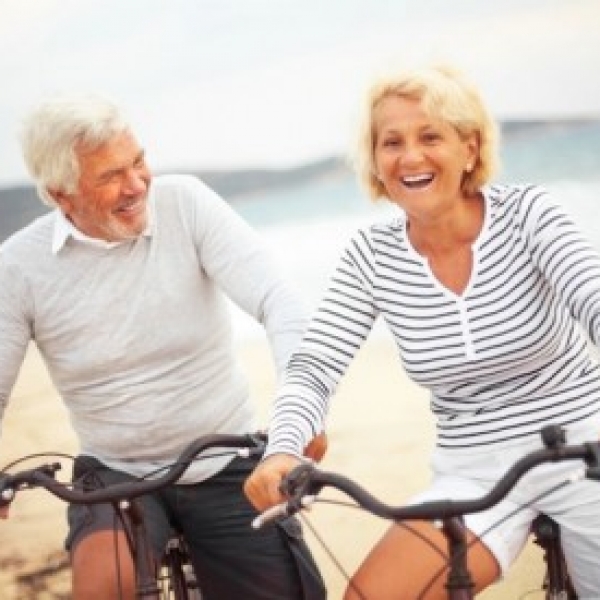 couple riding bikes at the beach